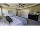 A well-lit main bedroom with carpet, ceiling fan, closet, and a view through the doorway to other rooms at 234 Crystal Springs Way, Benson, NC 27504