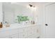 Bathroom vanity with double sinks, a large mirror, and white cabinets at 30 Imperial Oaks Ct, Youngsville, NC 27596
