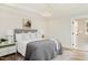 Comfortable bedroom with a tray ceiling, neutral color scheme, and an ensuite bathroom at 30 Imperial Oaks Ct, Youngsville, NC 27596