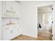 Chic butlers pantry with white cabinetry, gold hardware, and convenient shelving at 30 Imperial Oaks Ct, Youngsville, NC 27596