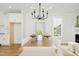 Dining room with modern chandelier and natural light, with a table set for six at 30 Imperial Oaks Ct, Youngsville, NC 27596