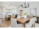 Elegant dining area with wood table and modern chandelier next to open-concept kitchen and island seating at 30 Imperial Oaks Ct, Youngsville, NC 27596