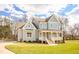 Attractive two-story home featuring a charming front porch and landscaped yard at 30 Imperial Oaks Ct, Youngsville, NC 27596