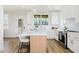 Bright kitchen with white cabinets, stainless steel appliances, and an island with seating at 30 Imperial Oaks Ct, Youngsville, NC 27596