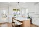 Bright kitchen featuring white cabinets, quartz countertops, an island with seating, and stainless appliances at 30 Imperial Oaks Ct, Youngsville, NC 27596