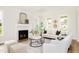 Bright living room with fireplace, large windows, and stylish decor offers a cozy and inviting atmosphere at 30 Imperial Oaks Ct, Youngsville, NC 27596