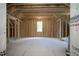 Unfinished bonus room with exposed wooden framing and a single window at 30 Imperial Oaks Ct, Youngsville, NC 27596