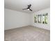 Bright bedroom with carpet flooring, a ceiling fan, and a large window offering natural light at 122 W Beech Slope Ct, Chapel Hill, NC 27517