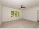 Bright bedroom with carpet flooring, a ceiling fan, and a large window offering natural light at 122 W Beech Slope Ct, Chapel Hill, NC 27517