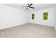 Bright, carpeted bedroom with a ceiling fan and two windows providing plenty of natural light at 122 W Beech Slope Ct, Chapel Hill, NC 27517