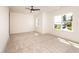 Bright, carpeted bedroom with a ceiling fan and large windows at 122 W Beech Slope Ct, Chapel Hill, NC 27517