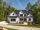 Beautiful two-story home featuring a painted brick exterior and pristine landscaping at 122 W Beech Slope Ct, Chapel Hill, NC 27517