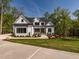 Stunning two-story home with a modern white brick exterior and lush green lawn at 122 W Beech Slope Ct, Chapel Hill, NC 27517