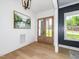 Bright foyer featuring hardwood floors, statement lighting and a view of the front entrance at 122 W Beech Slope Ct, Chapel Hill, NC 27517