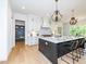 Spacious kitchen boasting white cabinetry, an island with seating, and high-end appliances at 122 W Beech Slope Ct, Chapel Hill, NC 27517