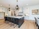 Bright, modern kitchen features a large island with a breakfast bar and pendant lighting at 122 W Beech Slope Ct, Chapel Hill, NC 27517
