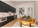 Dining nook with black cabinets, white backsplash, stainless appliances, and a wood table at 122 W Beech Slope Ct, Chapel Hill, NC 27517