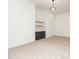 Bright living room with built-in shelves, a dark cabinet, and modern light fixture at 122 W Beech Slope Ct, Chapel Hill, NC 27517