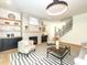 Open-concept living room featuring a fireplace, built-in shelving, and a stylish rug at 122 W Beech Slope Ct, Chapel Hill, NC 27517
