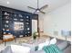 Open living room with custom built-ins, hardwood floors, modern decor, and natural light at 122 W Beech Slope Ct, Chapel Hill, NC 27517