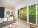 Open living room with view to back deck via sliding glass doors, and a dining area in the background at 122 W Beech Slope Ct, Chapel Hill, NC 27517