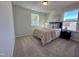 Cozy bedroom with a queen bed and neutral decor at 141 Beacon Hill Rd # 13, Lillington, NC 27546