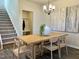 Bright dining room with wood table and modern chandelier at 141 Beacon Hill Rd # 13, Lillington, NC 27546