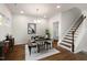 Bright dining room features a modern table and chairs, hardwood floors, and a stylish chandelier at 141 Beacon Hill Rd # 13, Lillington, NC 27546