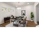Elegant dining room with hardwood floors, modern chandelier, and ample natural light at 141 Beacon Hill Rd # 13, Lillington, NC 27546
