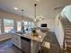 Open concept kitchen with granite island and stainless steel appliances at 141 Beacon Hill Rd # 13, Lillington, NC 27546