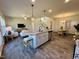 Modern kitchen island with granite countertop and stainless steel appliances at 141 Beacon Hill Rd # 13, Lillington, NC 27546