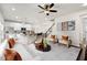 Open concept living room with kitchen access, featuring hardwood floors and stylish furnishings at 141 Beacon Hill Rd # 13, Lillington, NC 27546