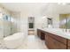 Bright bathroom with marble floors, walk-in shower, and a modern bathtub with chrome fixtures at 43 Laurel Knoll Dr, Pittsboro, NC 27312