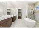 Luxurious bathroom with double vanities, soaking tub, and marble shower at 43 Laurel Knoll Dr, Pittsboro, NC 27312