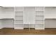 Custom walk-in closet with wooden floors featuring built-in shelving and storage at 43 Laurel Knoll Dr, Pittsboro, NC 27312