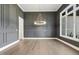 Dining room featuring gray walls, large window and modern light fixture at 43 Laurel Knoll Dr, Pittsboro, NC 27312