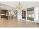 Dining area with hardwood floors and view to the kitchen, living area, and outside patio at 43 Laurel Knoll Dr, Pittsboro, NC 27312