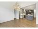 Open concept dining area featuring hardwood floors, chandelier, and a view to the kitchen at 43 Laurel Knoll Dr, Pittsboro, NC 27312