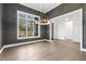 Beautiful dining room with gray walls, hardwood floors, modern chandelier, and view to the next room at 43 Laurel Knoll Dr, Pittsboro, NC 27312