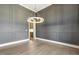 Bright dining room with hardwood floors, gray walls, modern chandelier, and an entry to the kitchen at 43 Laurel Knoll Dr, Pittsboro, NC 27312