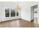 Dining area featuring wood floors, chandelier, and view of the wooded back yard at 43 Laurel Knoll Dr, Pittsboro, NC 27312
