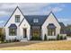 Elegant home with a distinctive architectural style and a well-landscaped front yard at 43 Laurel Knoll Dr, Pittsboro, NC 27312