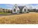 Charming white brick home with modern black trim and a well-maintained front yard at 43 Laurel Knoll Dr, Pittsboro, NC 27312