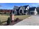 Beautiful two-story home with landscaped yard, elegant dark trim, and driveway at 43 Laurel Knoll Dr, Pittsboro, NC 27312