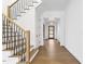 Hallway featuring decorative stairs and hardwood floors at 43 Laurel Knoll Dr, Pittsboro, NC 27312