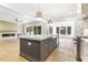Spacious kitchen with island, stainless steel appliances, and open view to living and dining area at 43 Laurel Knoll Dr, Pittsboro, NC 27312