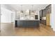 Modern kitchen island featuring gray cabinets, quartz countertops, and pendant lighting at 43 Laurel Knoll Dr, Pittsboro, NC 27312