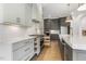 Modern kitchen with white cabinets, stainless steel appliances, and gray island with marble counters at 43 Laurel Knoll Dr, Pittsboro, NC 27312