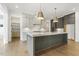 Kitchen with gray cabinets, stainless steel appliances, and a large island with bar seating at 43 Laurel Knoll Dr, Pittsboro, NC 27312