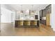 Modern kitchen island with gray cabinets, quartz countertops, and pendant lighting at 43 Laurel Knoll Dr, Pittsboro, NC 27312